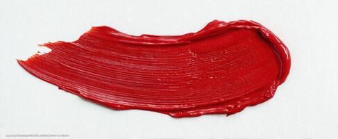 The red brushstroke showcasing vibrant artistry on a textured canvas. photo