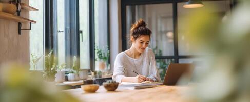 The young woman working intently at her stylish home office workspace. photo