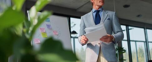 The businessman reviewing documents during a strategic meeting in a modern office. photo