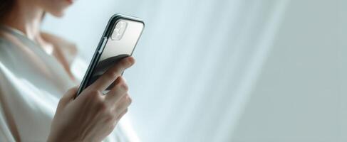 The elegant smartphone held by a person in a softly lit environment. photo