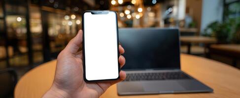 The smartphone displaying a blank screen in a modern workspace setting. photo