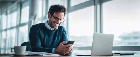 The man smiling while using his smartphone in a bright office space. photo