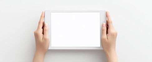 The tablet held in hands against a white background for mockup purposes. photo