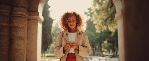 The woman enjoying a peaceful moment while texting in the park. photo