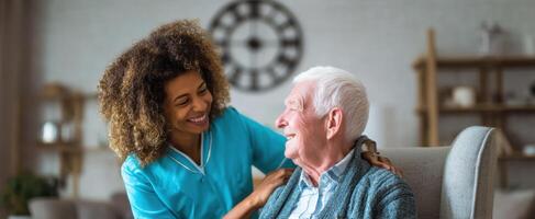 The elderly man enjoying a warm conversation with his caregiver in a cozy home setting. photo
