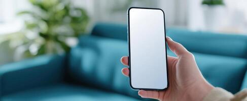The smartphone held up against a vibrant blue couch in a modern living space. photo
