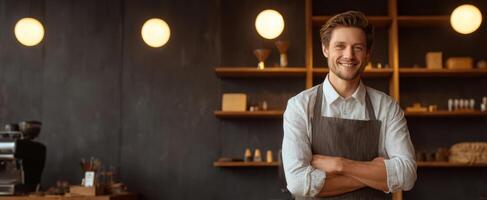 A smiling man in an apron standing in front of a coffee shop photo