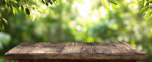 The rustic wooden table set against a vibrant green natural background. photo