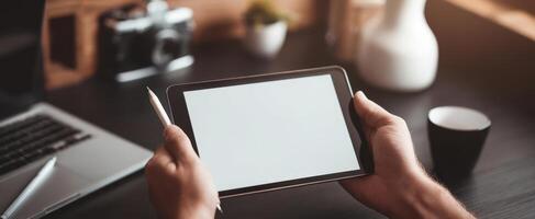 The tablet in a modern workspace with hands and a minimalist design. photo
