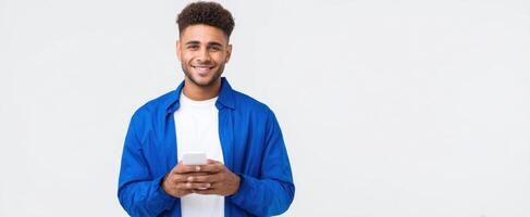 The smiling man with a smartphone in a casual blue jacket. photo