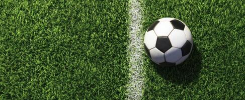 The soccer ball positioned on the vibrant green turf of a field. photo