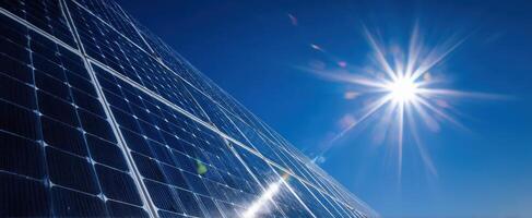 The solar panels reflecting sunlight under a clear blue sky. photo