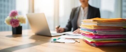 The busy office professional working diligently at a cluttered desk. photo