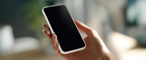 The smartphone held in a hand with a blurred background setting photo