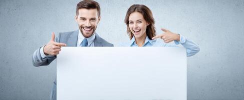 The smiling couple presenting a blank sign for advertising and marketing purposes. photo