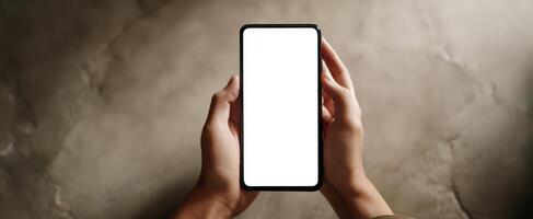 The smartphone held by hands showcasing a blank, empty screen for mockup use. photo