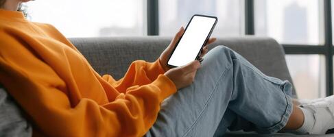 The woman using a smartphone in a stylish living room setting. photo