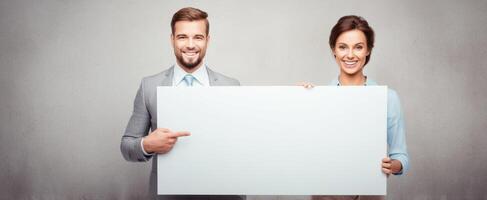The business couple presenting an empty sign for customizable advertising opportunities. photo