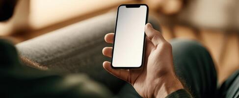 The smartphone held by a person in a relaxed indoor setting. photo