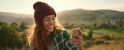 The cheerful woman enjoying a smartphone in a serene outdoor setting. photo