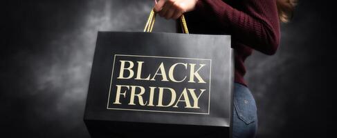 The stylish shopper holding a Black Friday bag in excitement. photo