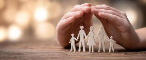 The gentle hands protecting a family of figurines representing love and unity. photo