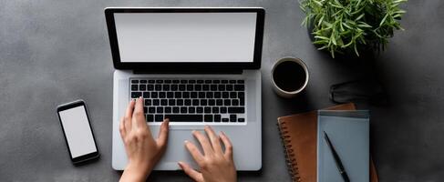 The sleek laptop setup with coffee and stationery on a modern desk photo