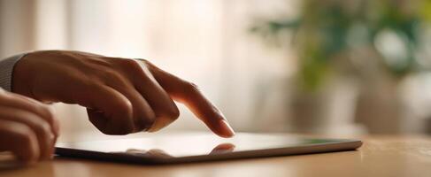 The finger gently interacts with the touchscreen tablet in a modern workspace. photo