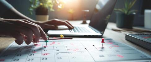The calendar marked with pins for effective planning and productivity. photo