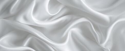 The Elegant White Silk Fabric Draped Beautifully on a Smooth Surface photo