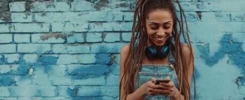 The joyful young woman enjoying music while texting on her smartphone. photo