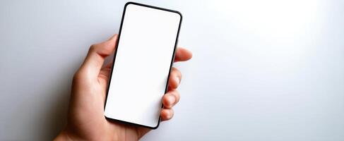 The smartphone held in hand with a blank screen for customization. photo