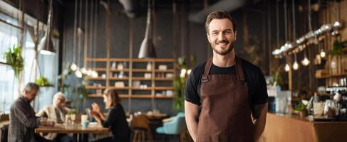 A man in an apron standing in a restaurant photo