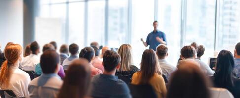 The speaker engaging an attentive audience during a professional seminar or workshop. photo