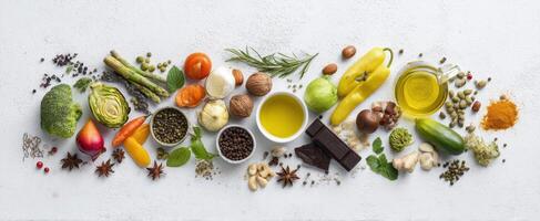 The assortment of fresh vegetables, fruits, and herbs on a textured surface photo