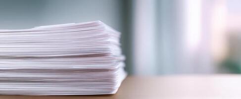 The neatly organized stack of paperwork on a modern desk environment. photo