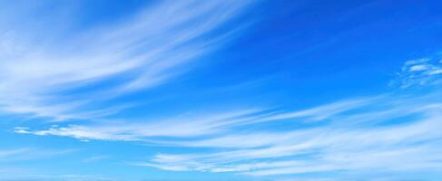 The Expansive Blue Sky with Gentle White Clouds on a Sunny Day photo
