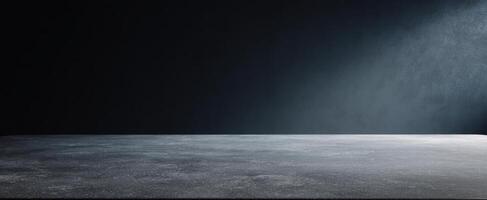 The empty concrete surface illuminated by soft dramatic light in a dark space. photo