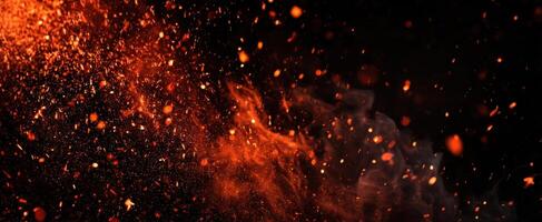 The mesmerizing display of fiery particles and glowing embers against a dark backdrop photo