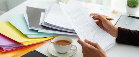 The organized workspace with colorful folders and a cup of coffee. photo