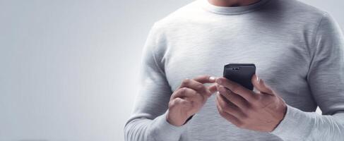 The modern man interacting with a smartphone in a minimalistic setting. photo