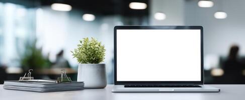 The modern laptop and greenery in a stylish office environment. photo