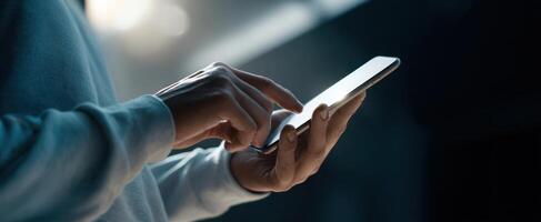 The human hand interacting with a smartphone in a dimly lit environment photo