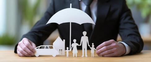 The protective umbrella over family, home, and car representing insurance and security. photo
