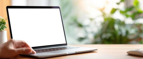 Laptop with blank screen on wooden table photo