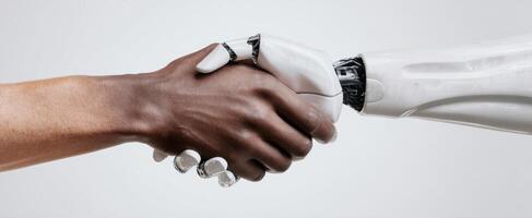 The handshake between human and robotic arm symbolizing future collaboration. photo