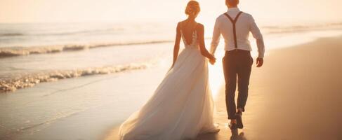 The romantic couple walking hand in hand along a sunlit beach at sunset. photo