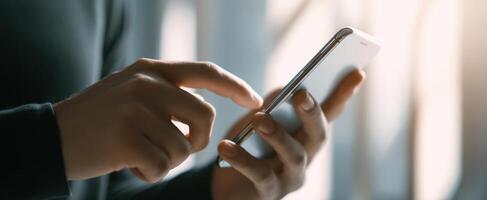 The smartphone interaction in a modern lifestyle setting with natural light. photo