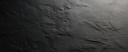 The textured black surface with unique natural patterns and artistic appeal. photo