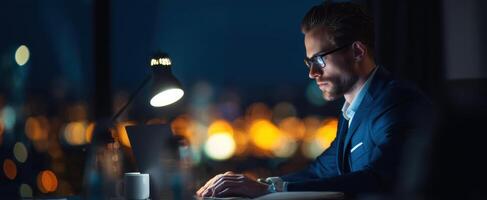 The focused businessman working late at night with a city view. photo